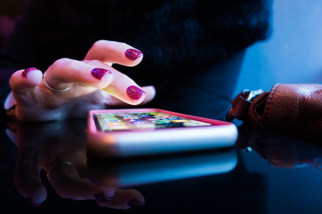 woman about to make a donation to a non-profit website using her smartphone